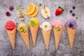 Various of ice cream flavor in cones blueberry ,green tea ,pistachio ,almond ,orange and cherry setup on dark stone background . Royalty Free Stock Photo