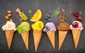 Various of ice cream flavor in cones blueberry ,green tea ,pistachio ,almond ,orange and cherry setup on dark stone background . Royalty Free Stock Photo