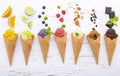 Various of ice cream flavor in cones blueberry ,lime ,pistachio ,almond ,orange ,chocolate ,vanila and coffee setup on shappy Royalty Free Stock Photo