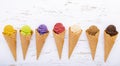 Various of ice cream flavor in cones blueberry ,lime ,pistachio ,almond ,orange ,chocolate ,vanila and coffee setup on shappy Royalty Free Stock Photo