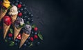 Various of ice cream flavor in cones blueberry ,strawberry ,pistachio ,almond ,orange and cherry setup on dark stone background . Royalty Free Stock Photo