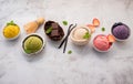 Various of ice cream  flavours in bowl blueberry ,green tea ,coconut ,strawberry and chocolate  setup on white stone background Royalty Free Stock Photo