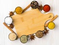 Various Indian spices in metal cups. Empty wooden Board, seasoning on white wooden table. top view, space for text. Royalty Free Stock Photo