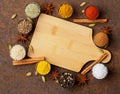 Various Indian spices in metal cups. Empty wooden Board, top vie