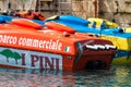 Various Italian speed boats docked to pier