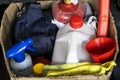 Various items in cardboard box. Can of water, watering can, rags. Things in trunk of car Royalty Free Stock Photo