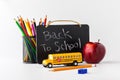 Various items to depict a back to school concept against a white background. Royalty Free Stock Photo