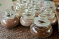 Various jars of coffee and chocolate on wooden tray