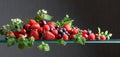 Various juicy berries with leaves Royalty Free Stock Photo