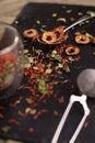 Various kind of organic dried herbs, fruit and flower decorated with tea infuser on black background. Royalty Free Stock Photo