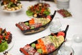 Various kind of sushi food served on boat capacity.Different Types of Maki Sushi and Nigiri Sushi. Royalty Free Stock Photo