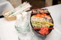 Various kind of sushi food served on boat capacity.Different Types of Maki Sushi and Nigiri Sushi. Royalty Free Stock Photo