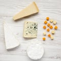Various kinds of cheeses on white wooden surface Royalty Free Stock Photo