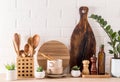 Various kinds of kitchen utensils, wooden boards, spice containers, green potted plant on a modern countertop. fashionable kitchen Royalty Free Stock Photo