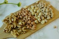 various kinds of nuts, walnuts, peanuts, hazelnut and chickpea on the cutting board