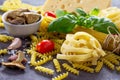 Various kinds of pasta ingredients with mushrooms, basil, cherry tomato, garlic, pepper, cheese Royalty Free Stock Photo