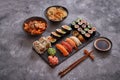 Various kinds of sushi placed on black stone board Royalty Free Stock Photo