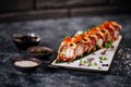 Various kinds of sushi served on black stone