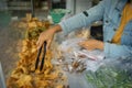 the seller uses tong tongs to select and pick up the fried foods before inserting the plastic bag