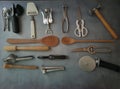 Various kitchen tools: peeler, grater, wooden spoon, garlic crusher, cheese slicer,
