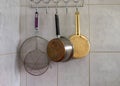 Various kitchen utensils on the hanger on the wall, eat cooking Royalty Free Stock Photo