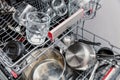 Various kitchen utensils loaded into the dishwasher inside Royalty Free Stock Photo