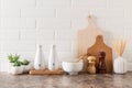 Various kitchen utensils on a marble countertop in a modern kitchen. the concept of decor against the background of a white brick Royalty Free Stock Photo