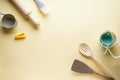 Various kitchen utensils on a yellow background, top view, with place for text