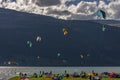 Various kite surfers in action on Lake Resia shot against the light in Curon Venosta, South Tyrol, Italy