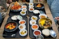 Various of korean food with spicy soup, kimchi, noodles and vegetable pickle on tray