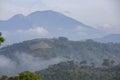 the various layers of hills and the upright mountains stand firm and are crossed by clouds in the morning