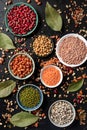 Various legumes, shot from the top on a dark background. Lentils, soybeans, chickpeas, red kidney beans, black-eyed peas and other