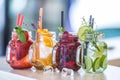 Various lemonades in mason jars with orange lime lemon otange st