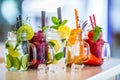 Various lemonades in mason jars with orange lime lemon otange st