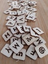 Various letters of the alphabet on a wood background