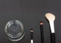 Various luxury makeup products on dark background, flat styling Royalty Free Stock Photo