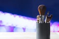 Various make up brushes in container on table