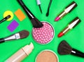 Various makeup products on green background Royalty Free Stock Photo