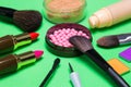 Various makeup products on green background Royalty Free Stock Photo