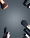 Various makeup products on a plain background