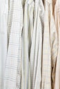 Various male shirts on hangers in wardrobe