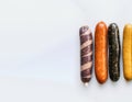 Various meat fresh sausages lie in a row, white background, isolate. AI generated.