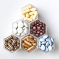 Various medical capsules and tablets in hexagonal jars