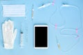 Various medical equipment and tablet on blue background