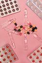 Various Medication on Pink Background