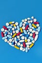 Various medicine pills arranged in heart shape vertical