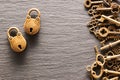 Various metal keys and locks on slate background