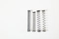 Various metal springs for different purposes, many small chrome springs Royalty Free Stock Photo