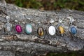 Mineral gem stone silver pendants on tree background
