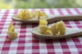 Various mix of pasta on wooden spoons on purple white checkered tablecloth, shapes ruotes and macaroni Royalty Free Stock Photo